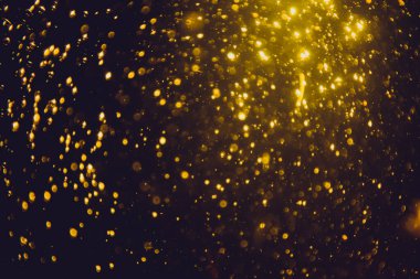 Siyah arkaplan ile soyut altın bokeh