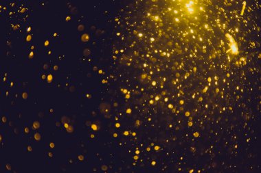 Siyah arkaplan ile soyut altın bokeh