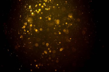 Siyah arkaplanda koyu soyut altın bokeh parıltısı