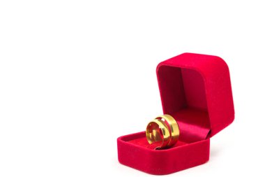Beyaz arka planda kırmızı kadife kutuda alyans