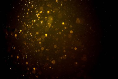 Siyah arkaplanda koyu soyut altın bokeh parıltısı
