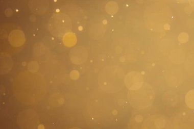 Siyah arkaplanda koyu soyut altın bokeh parıltısı