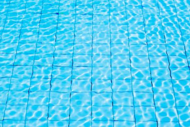 Blue ripe water reflection in swimming pool background