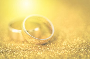 Gelinin ve damadın altın alyansları altın kaplama arka planda