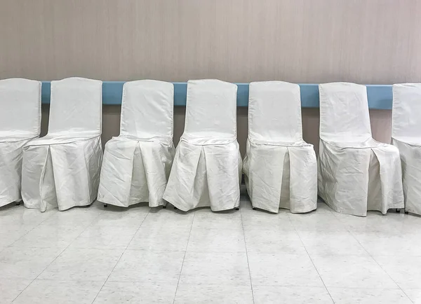 Chairs covered with a white fabric