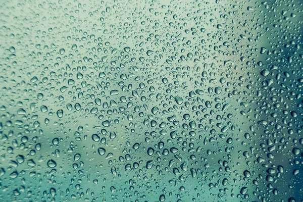 Pencere camındaki su damlası, siyah zemin.