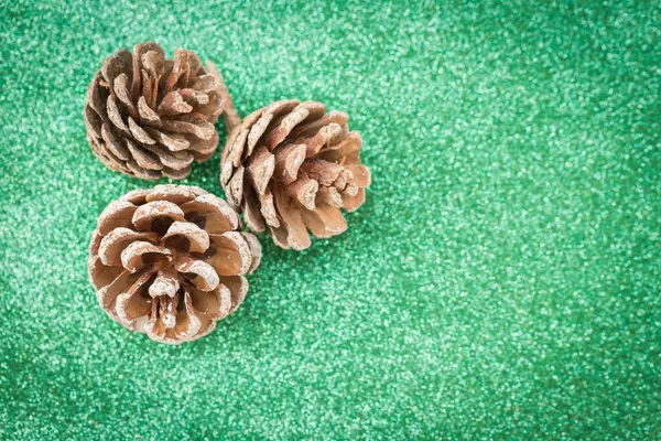 Dried Pine Balls Green Glitter Background — Fotografia de Stock