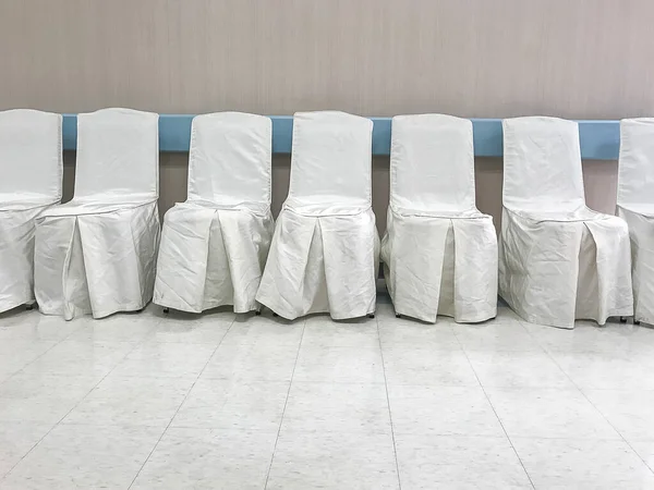 Chairs covered with a white fabric