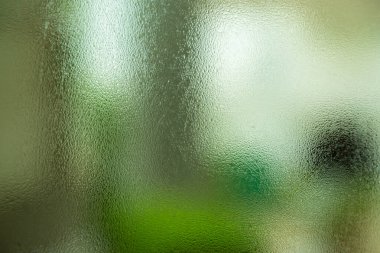 natural behind the wet glass with water drops on the glass background