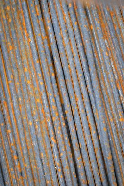 Old rusted steel bars laid on the ground use for background