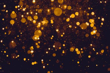 Siyah arkaplanda altın renkli ışıklar