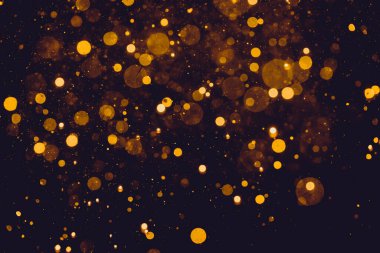 Siyah arkaplanda altın renkli ışıklar