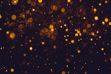 Siyah arkaplanda altın renkli ışıklar