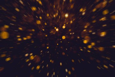 Siyah arkaplanda altın renkli ışıklar