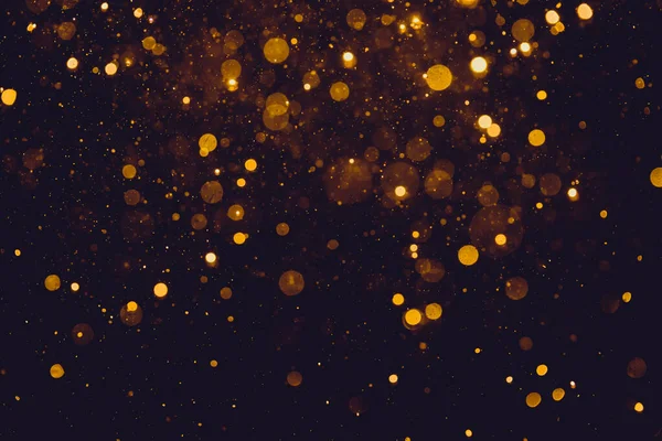 Siyah arkaplanda altın renkli ışıklar