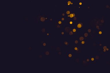 Fantezi altın bokeh siyah arkaplanda ışıktan parıldıyor