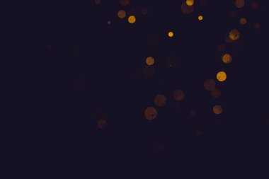 Fantezi altın bokeh siyah arkaplanda ışıktan parıldıyor