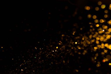 Siyah arkaplanda altın renkli ışıklar