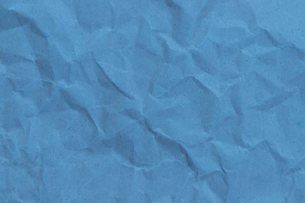 しわの質感の背景を持つ青い紙 — ストック写真