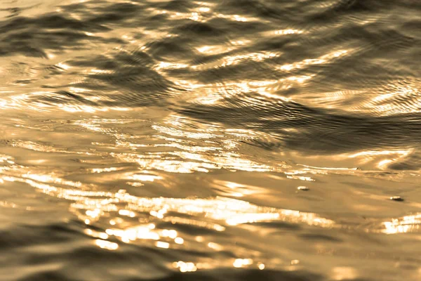 Yüzeyi Hareket Eden Altın Dalgalarıyla Yansıyor — Stok fotoğraf