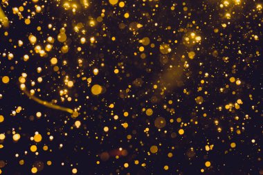 Siyah arkaplan ile soyut altın bokeh