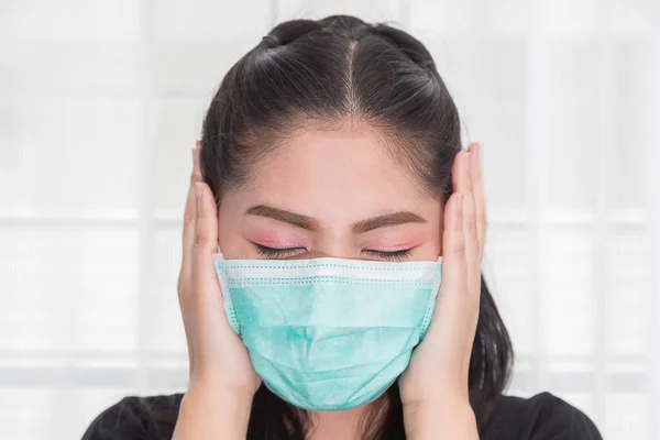 Asian woman wears a medical mask to protect against Covid\'s disease.