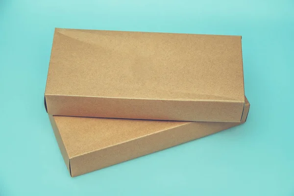 Empty Cardboard Box isolated on a green background