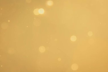 Siyah arkaplanda koyu soyut altın bokeh parıltısı