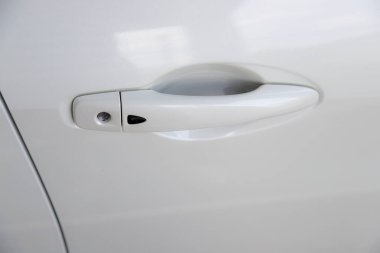 Color detail of a white car door - new car handle