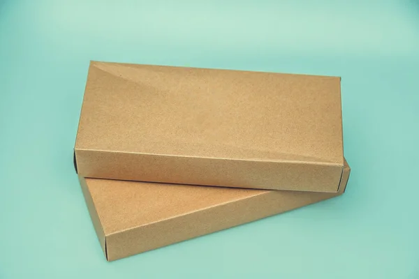 Empty Cardboard Box isolated on a green background