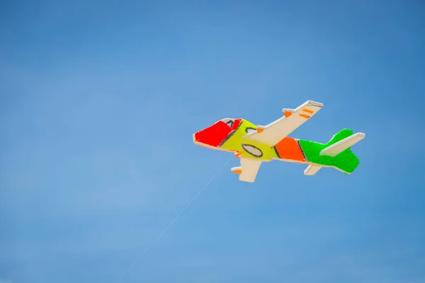 The toy plane is made of colorful foam to catch the wind on the beach.