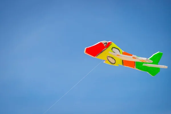 The toy plane is made of colorful foam to catch the wind on the beach.