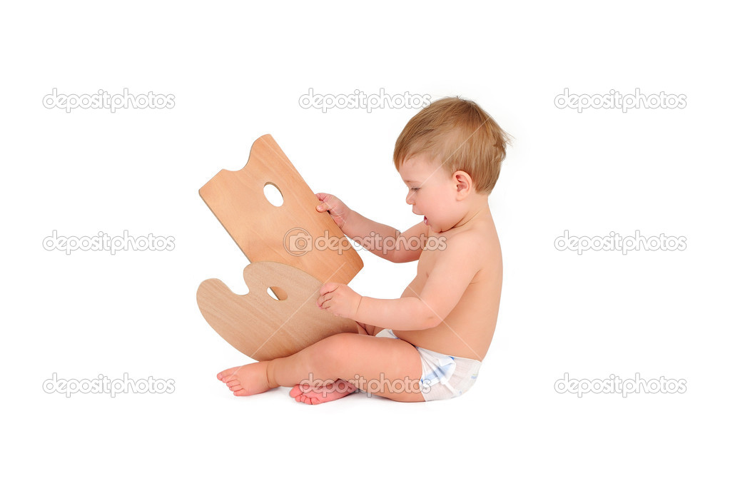 little boy with a palette in hands sits on a white background