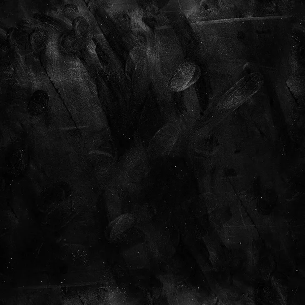 Grungy texture of brush strokes. Black background. Grunge. Chalkboard. Blackboard wallpaper. Close up retro plain dark black cement or concrete wall background texture.