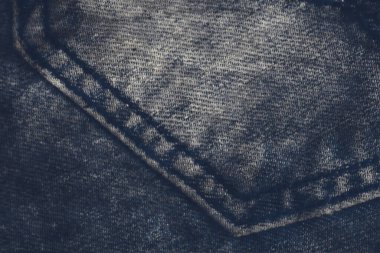 Denim fabric grunge texture background. Blue jeans pant texture background. Jeans backdrop pattern with vignetting. Classic blue texture. Background of denim canvas. Design element.