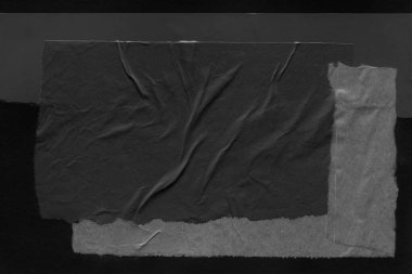 black and white dark Torn paper collage close-up. Texture made from various paper and cardboard parts. Damaged old paper background. Old grunge ripped torn vintage collage backdrop and background.