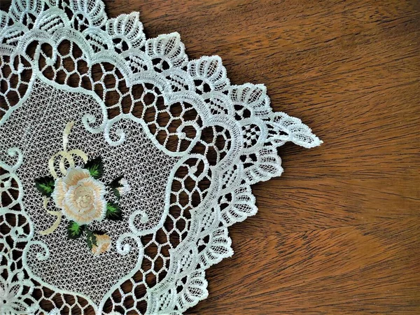 white lace fabric tablecloth, knitted cloth on wooden table