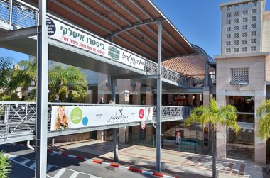 Two-level pedestrian bridge connecting two buildings in Kfar Sab clipart