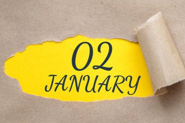 Ocak 02. Ayın 22 'si, takvim tarihi. Kenarları yırtılmış kağıt delikleri. Sarı arkaplan yırtık pırtık delikten görülebilir. Kış ayı, yılın günü konsepti..