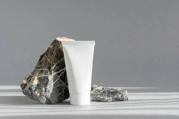 Mock White Tube Cosmetics Marble Stone Podium Plastic Container Cream Stock Image