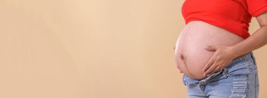 Woman standing and touching with hands her naked big belly. . Emotional loving pregnancy time - 38 weeks. Baby expectation. happiness and safety concept with copy space