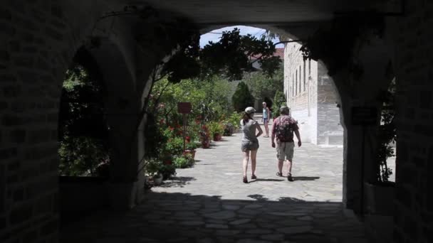 Turistů cestuje do kláštera přes oblouk — Stock video