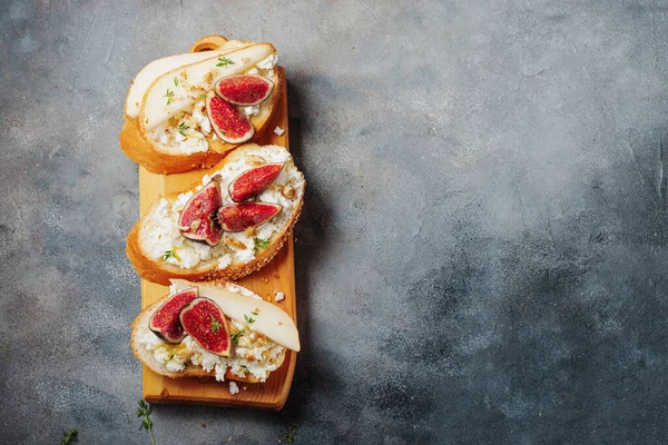 bruschetta with pears, cottage cheese, figs, thyme, nuts and honey. wine snacks