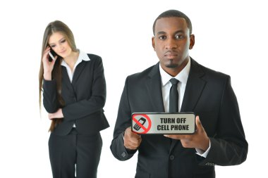 Business man holding Turn off cell phone sign  with serious expression clipart