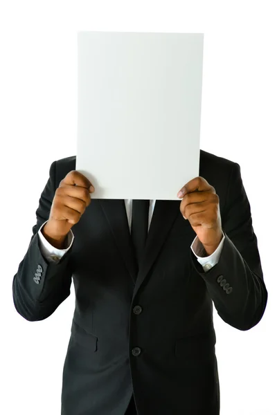 Uomo d'affari che tiene il bianco vuoto davanti al viso — Foto Stock