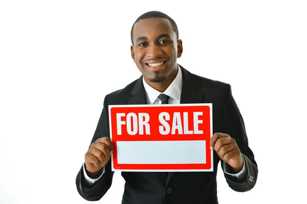 Businessman holding for sale sign — Stock Photo, Image