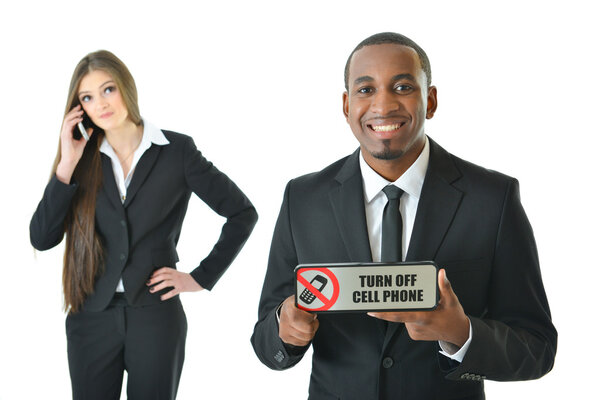 Business man holding Turn off cell phone sign  with smiling expression