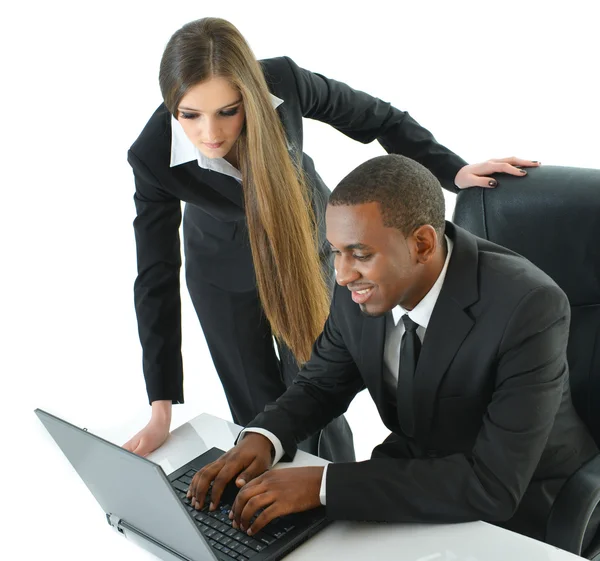 Businessman and businesswoman working together on laptop — Stock Photo, Image