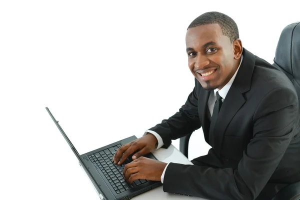 Businessman with laptop sitting at desk — Stock Photo, Image