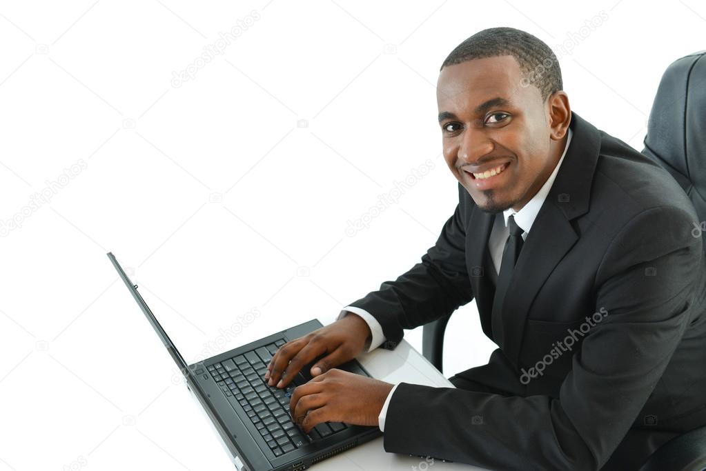 Businessman with laptop sitting at desk